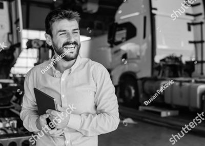 Transportation worker holding tablet and smiling