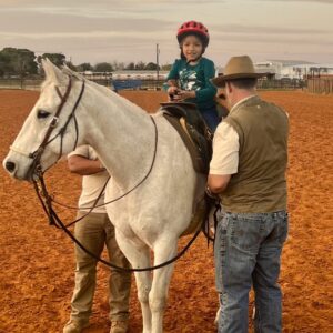 Young girl riding horse